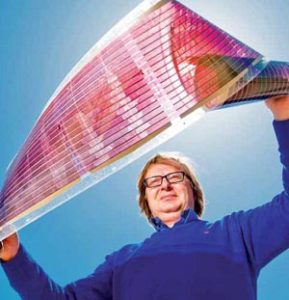 Prof. Eugene Katz holds a prototype of a promising new solar energy technology.