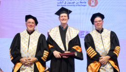 Three men in academic robes and mortarboards at Ben-Gurion University graduation ceremony