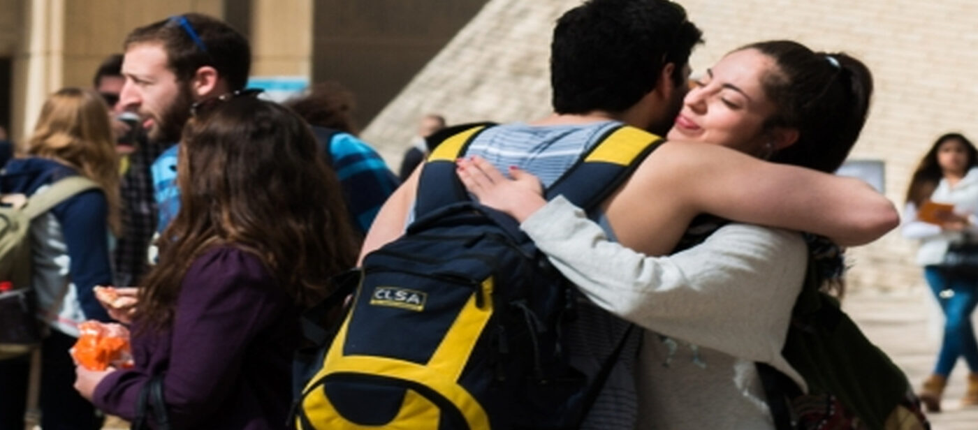Two Ben-Gurion University students hugging on campus